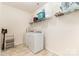 This laundry room has a washer, a dryer, and wire shelving at 7113 Meridale Forest Dr, Charlotte, NC 28269