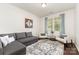 Bright living room with a gray couch, two chairs, patterned rug and plenty of natural light at 7113 Meridale Forest Dr, Charlotte, NC 28269