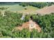 Aerial view of the property showing the home, surrounding trees, and open land at 720 Cricket Ln, Mt Ulla, NC 28125