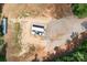 Aerial shot of a rural lot, showing an outbuilding and house, surrounded by fields and trees at 720 Cricket Ln, Mt Ulla, NC 28125