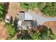 Top-down view of secluded residence with long driveway, surrounded by a mix of green foliage and red dirt at 720 Cricket Ln, Mt Ulla, NC 28125