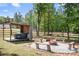 Backyard oasis featuring a hot tub under a wooden structure and a cozy fire pit area at 720 Cricket Ln, Mt Ulla, NC 28125