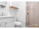 This bathroom features a tiled shower, vanity with a sink, a mirror and a cabinet for storage at 720 Cricket Ln, Mt Ulla, NC 28125