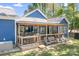 Spacious covered deck with outdoor bar, seating, and charming string lights for entertaining at 720 Cricket Ln, Mt Ulla, NC 28125
