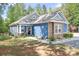 Beautiful blue home featuring stone accents, manicured landscaping, and a welcoming front porch at 720 Cricket Ln, Mt Ulla, NC 28125