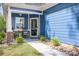 Inviting front porch with rocking chairs, a welcome sign, and charming stone accents at 720 Cricket Ln, Mt Ulla, NC 28125