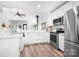 Modern white kitchen with stainless steel appliances, breakfast bar, and ample counter space at 720 Cricket Ln, Mt Ulla, NC 28125