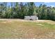 Expansive lot showcasing a trailer parked on a gravel area amidst the surrounding green landscape at 720 Cricket Ln, Mt Ulla, NC 28125