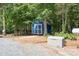 Exterior of the blue storage shed, showcasing its usefulness as an addition to the property at 720 Cricket Ln, Mt Ulla, NC 28125