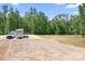 Wide open property with space for equipment and potential development amidst a wooded backdrop at 720 Cricket Ln, Mt Ulla, NC 28125
