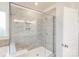 This bathroom features a glass shower enclosure with tiled walls and a built-in bench, next to the door at 8286 Ashvale Nw St, Concord, NC 28027