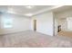 Light filled bedroom with neutral carpet, tray ceiling, and natural light from a window at 8286 Ashvale Nw St, Concord, NC 28027