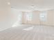 Bright bonus room with neutral carpet and multiple windows providing ample natural light at 8286 Ashvale Nw St, Concord, NC 28027