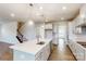 Spacious kitchen island with quartz countertop, stainless steel appliances, and an open view of the staircase at 8286 Ashvale Nw St, Concord, NC 28027