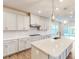 Open concept kitchen with white cabinets, subway tile backsplash, stainless steel appliances, and a large center island at 8286 Ashvale Nw St, Concord, NC 28027
