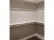 Walk-in closet with ample shelving and wooden rods providing plenty of storage space at 835 A Wynnshire Dr # 53, Hickory, NC 28601