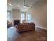 A well-lit living room featuring a fireplace, hardwood floors, neutral paint, and ample natural light at 835 A Wynnshire Dr # 53, Hickory, NC 28601