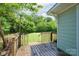 A wooden back deck overlooks a large grassy lawn surrounded by mature trees at 917 Laye St, Belmont, NC 28012