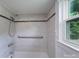 Shower with elegant tile-work and a convenient hand-held shower head at 917 Laye St, Belmont, NC 28012