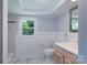 Bathroom featuring a shower/tub combo with marble tile and a wooden vanity at 917 Laye St, Belmont, NC 28012