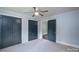 Comfortable bedroom with plush carpet, a ceiling fan, and blue accent walls at 917 Laye St, Belmont, NC 28012
