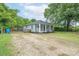 Charming home with light blue siding, a cozy screened-in porch, and a gravel driveway at 917 Laye St, Belmont, NC 28012