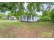 Charming home with light blue siding, a cozy screened-in porch, and a well-maintained yard at 917 Laye St, Belmont, NC 28012