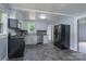 Updated kitchen with modern appliances, gray tile flooring, and light blue walls at 917 Laye St, Belmont, NC 28012
