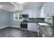 Updated kitchen with modern appliances, gray tile flooring, and light blue walls at 917 Laye St, Belmont, NC 28012