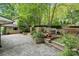 Multi-tiered backyard with a stone paver patio, wooden deck, and lush landscaping at 920 Habersham Dr, Charlotte, NC 28209