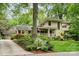 Beautiful two-story home with a covered porch, vibrant landscaping, and a paved driveway at 920 Habersham Dr, Charlotte, NC 28209