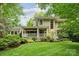 Charming home featuring a covered porch, lush landscaping, and a well-manicured lawn at 920 Habersham Dr, Charlotte, NC 28209