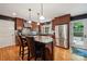 Modern kitchen features stainless steel appliances, wood cabinetry, granite counters, and hardwood floors at 920 Habersham Dr, Charlotte, NC 28209