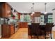 Well-equipped kitchen with stainless appliances, dark wood cabinets, granite countertops, and hardwood floors at 920 Habersham Dr, Charlotte, NC 28209