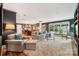 Open-concept living room and kitchen featuring dark accent walls and lots of natural light at 920 Habersham Dr, Charlotte, NC 28209