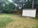 Spacious backyard featuring a storage shed and a newly installed wooden privacy fence. Perfect for outdoor activities and relaxation at 9207 Branson Ct, Charlotte, NC 28210