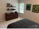 Bedroom showing tasteful décor with record player and wall-mounted shelving at 9207 Branson Ct, Charlotte, NC 28210
