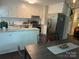 Bright kitchen featuring white cabinets, a breakfast bar, stainless steel appliances, and hardwood floors at 9207 Branson Ct, Charlotte, NC 28210