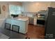 Well-lit kitchen featuring white cabinetry, granite countertops, stainless steel appliances, and modern fixtures at 9207 Branson Ct, Charlotte, NC 28210