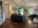 Bright and airy living room featuring hardwood floors, modern decor, and plenty of natural light. Ideal for comfortable living at 9207 Branson Ct, Charlotte, NC 28210