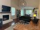 Open concept living room with a fireplace and view into dining area at 9207 Branson Ct, Charlotte, NC 28210