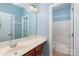 Bathroom featuring a single sink vanity, mirror, and walk in shower at 100 Oakwood Meadow Dr, Mooresville, NC 28115