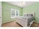 Bedroom with bright green walls, a window, and ceiling fan at 100 Oakwood Meadow Dr, Mooresville, NC 28115