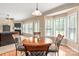 Cozy dining area with wood floors, bay windows, and adjacent view of the living room at 100 Oakwood Meadow Dr, Mooresville, NC 28115