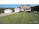 Charming two-story home with manicured lawn, attached garage, and covered front porch in a desirable neighborhood at 100 Oakwood Meadow Dr, Mooresville, NC 28115