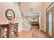 Welcoming foyer with hardwood floors, staircase, and a decorative display cabinet at 100 Oakwood Meadow Dr, Mooresville, NC 28115