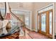Inviting foyer with hardwood floors, stained-glass front door, staircase, and living room view at 100 Oakwood Meadow Dr, Mooresville, NC 28115