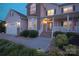Charming home exterior with a welcoming porch, manicured landscaping, and ambient lighting at 100 Oakwood Meadow Dr, Mooresville, NC 28115