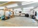 Large garage with storage cabinets, workbenches, and ceiling lights at 100 Oakwood Meadow Dr, Mooresville, NC 28115