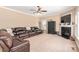 Inviting living room with a dark leather sofa, fireplace, and lots of space for living at 100 Oakwood Meadow Dr, Mooresville, NC 28115